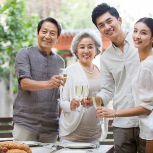 Happy Chinese family celebrating with champagne