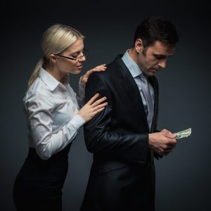 Businessman and businesswoman with money