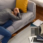 southeast-asian-male-lying-on-the-couch-and-holdin-2023-03-07-18-56-53-utc